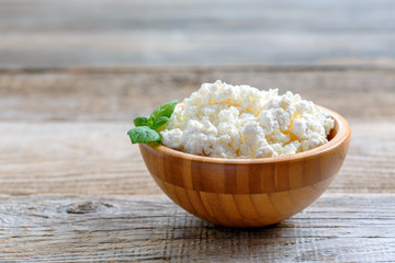 Homemade cottage cheese in a wooden bowl.