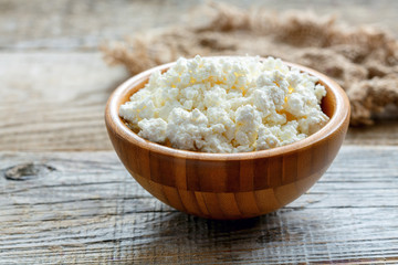 Wooden bowl with cottage cheese.