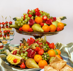 full glass vase of ripe tasty fruit