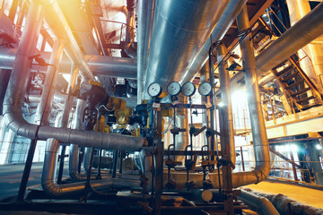 Equipment, cables and piping as found inside of a modern industr