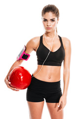 Fitness sexy woman standing and holding pilates ball