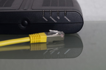 a dsl modem with a yellow networkcable