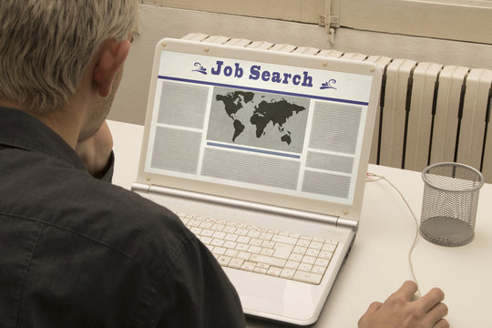 young man with a laptop looking for a job