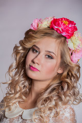 young and beautiful blonde with a wreath of flowers in her hair