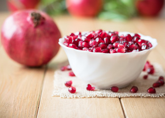 Still life with fresh pomegranate on a wooden table. Selective focus.