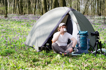 Tourist drinks tea in a tent camp.