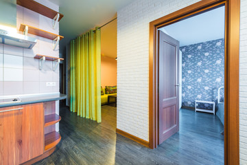 Modern elegant kitchen and a living room with a corridor