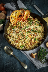 Mushroom Risotto in iron pan with herbs and parmesan cheese