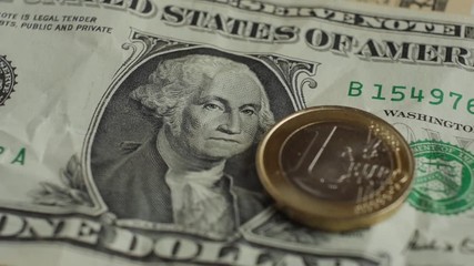 Euro coin and us dollar banknote background. Finance concept. Slow motion rotation. - Powered by Adobe