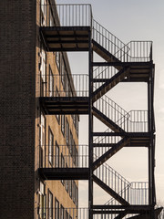 Iron Fire escape on exterior of brick built square building