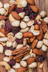 mixed nuts and cranberry on wooden background