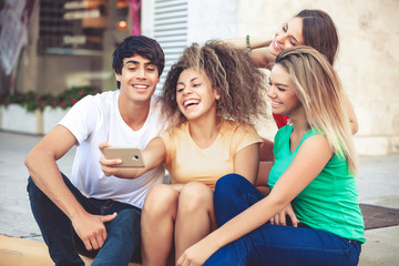 group of teenagers on the street doing selfie