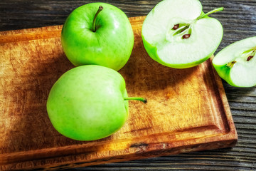 Ripe green apples on wooden background