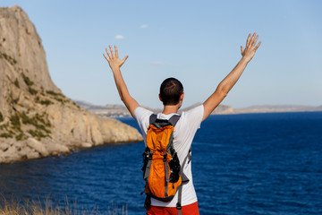 Man on hill near sea