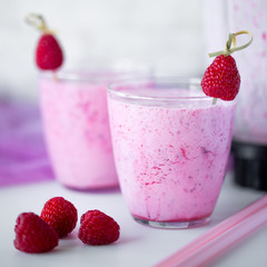 Fresh berry smoothie set of three glasses with blackberry and raspberry for healthy breakfast on white background