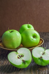 Ripe green apples on wooden background