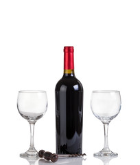 Unopened bottle of red wine and glasses isolated on white 