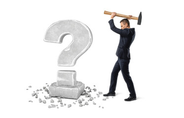 Businessman holding big hammer to crash question mark made of stone