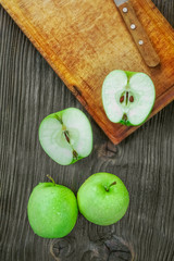 Ripe green apples on wooden background