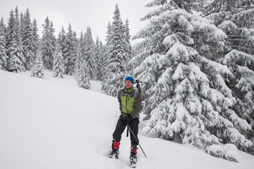 Fototapeta na wymiar Man, traveler relaxing and enjoying life in winter mountains