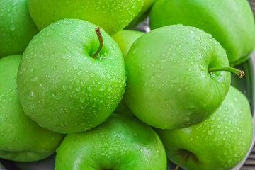 Ripe green apples on wooden background