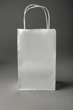 Blank paper bag on grey background