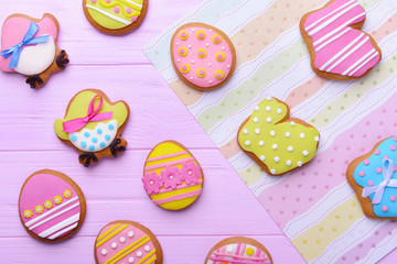 Closeup of delicious Easter cookies on colour background