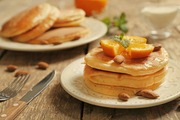 Stack of fresh pancakes on wooden table