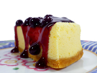 Closed up texture of baked cheesecake served with blueberry sauce 