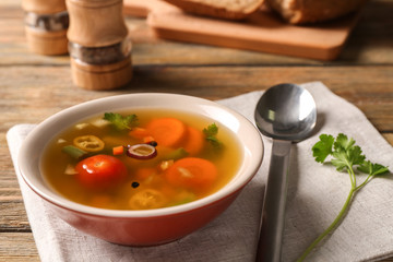 Bowl with fresh vegetable soup on napkin