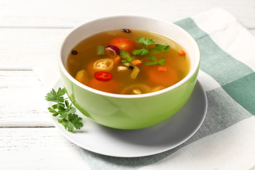 Bowl with fresh vegetable soup on napkin