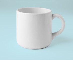 Blank ceramic cup on white background