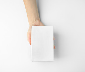 Female hand with box on white background
