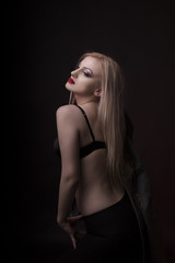 Fototapeta na wymiar Fashionable young model with bright makeup and in black lingerie