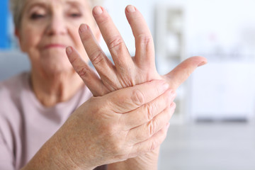 Elderly woman suffering from pain in hand, closeup - obrazy, fototapety, plakaty