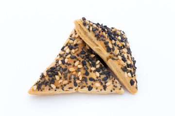 Crisps with nuts and seeds stacked on a white background.