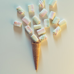 ice cream cone with bunch of marshmallows on white background