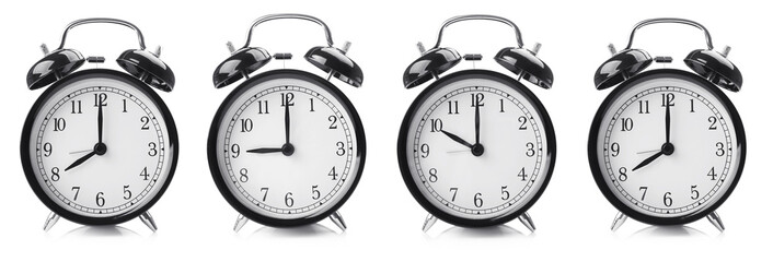 Time change concept. Alarm clocks on white background