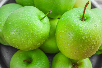 Ripe green apples on wooden background