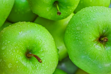 Ripe green apples on wooden background