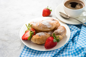 Mini croissants with berries and coffee.