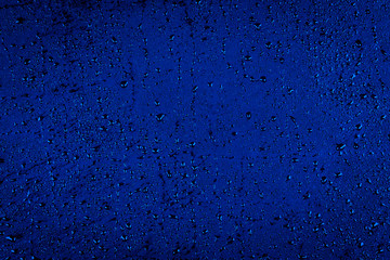 Fototapeta na wymiar Water drops on dark blue stone