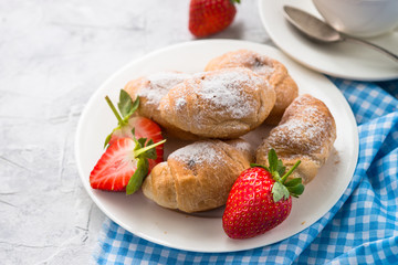 Mini croissants with berries and coffee.