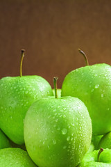 Ripe green apples on wooden background