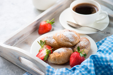 Mini croissants with berries and coffee. 