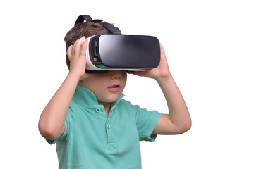 Amazed teen boy wearing virtual reality goggles watching movies or playing video games, isolated on white. Surprised teenager looking in VR glasses. Emotional portrait of child experiencing 3D gadget