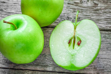 Ripe green apples on wooden background