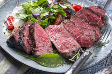 Barbecue dry aged Wagyu Point Steak with Italian Salad as close-up on a plate
