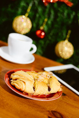 Mobile smartphone, coffee and pastry on light background. Closeup photo flat lay style