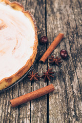 Homemade lemon pie on rustic wooden background.